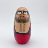 A handmade, handpainted wooden Daruma crafted by award-winning kokeshi artisan Shido Shozan