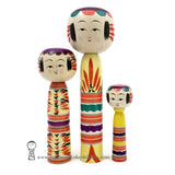 Three colorful kokeshi dolls by Takashi Kamata. Yajiro style traditional dento kokeshi in red, green, purple, yellow and black. Stripes and floral design. Adorable!