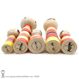 A photo showing the signature of kokeshi artist Takashi Kamata and Minae Kamata.