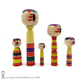 Kokeshi Family. Five Yajiro Kokeshi, Yellow with Stripes by Takashi Kamata. Dento Kokeshi.
