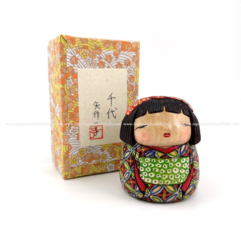 An extremely detailed, hand-carved and hand-painted kokeshi doll by legendary, award-winning kokeshi artist Ichiko Yahagi. The details in her kimono are fabulous and her expression is priceless!