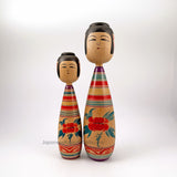 Kokeshi from Japan. Beautiful pair of vintage traditional kokeshi dolls handmade in tsugaru style. Striped kimonos with floral accents. A husband-wife pair. Gorgeous.
